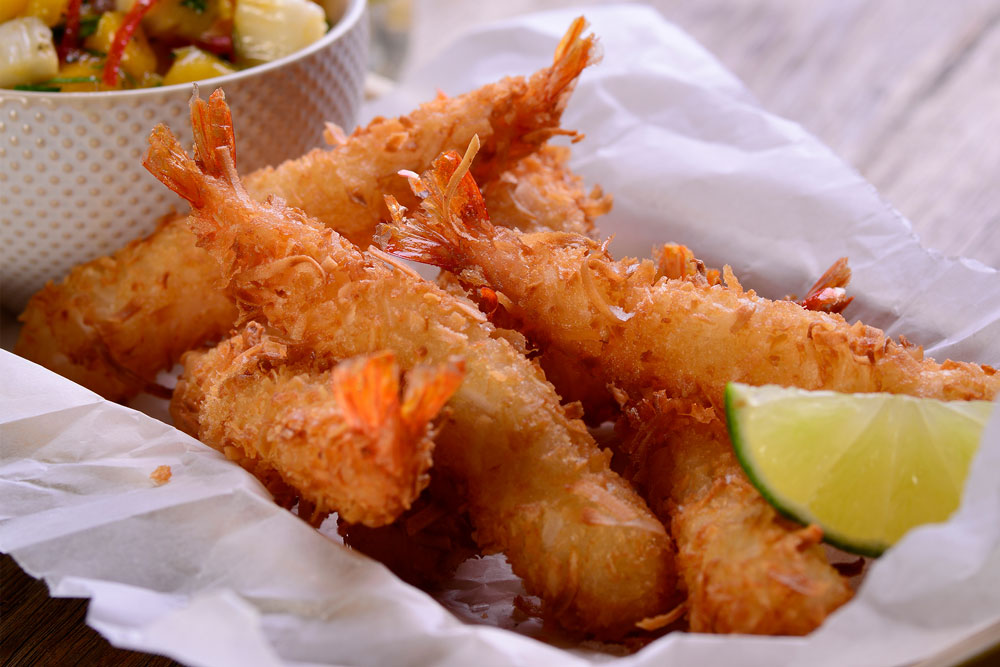 Cooked crumbed prawns with lime